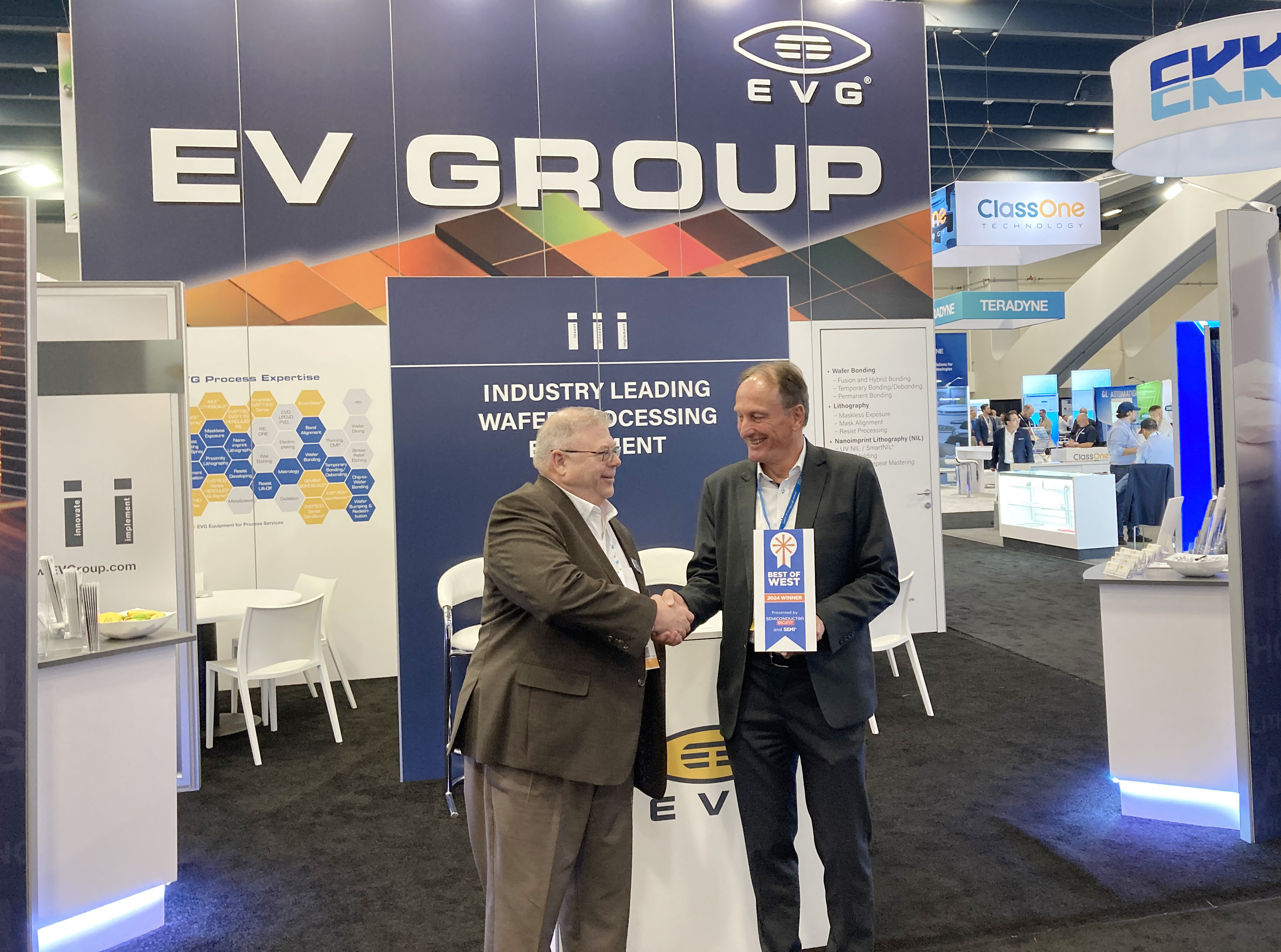 Semiconductor Digest's Editor-in-Chief Peter Singer handing over the award to EVG's Executive Sales & Customer Support Director Hermann Waltl.